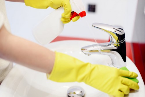 Technician treating a pet accident on upholstery in W10