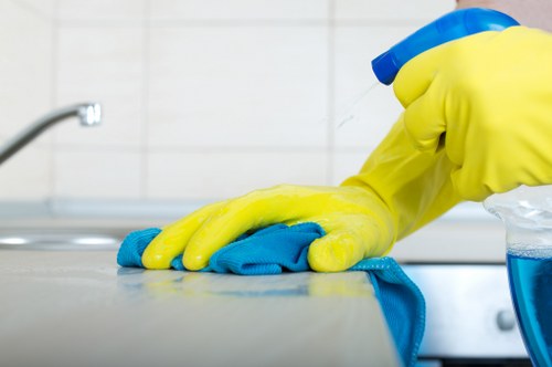 Cleaner using correct manual handling and housekeeping practices